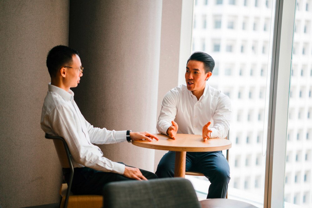 A portrait of two men in a serious discussion.