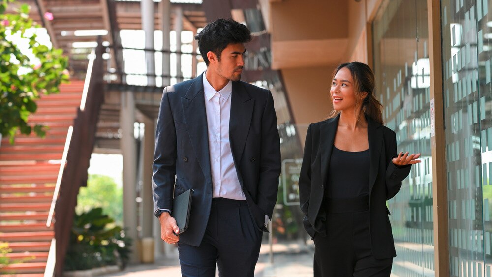 Woman executive talking to her male coworker.