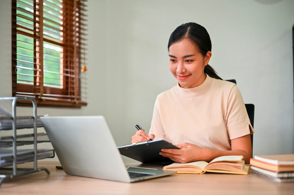 Asian professional with a clean work desk.