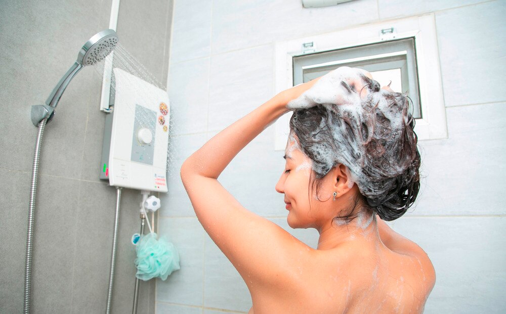 Woman shampooing her hair in the shower