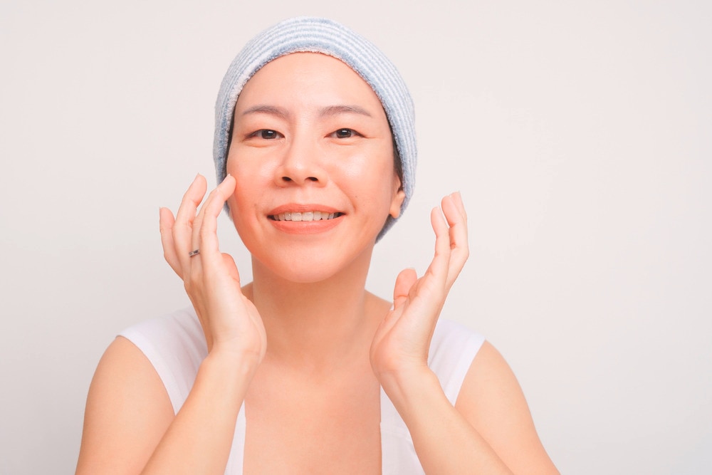 Portrait of a smiling woman after washing her face