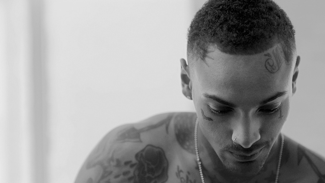 Profile view of a guy with a crew cut.