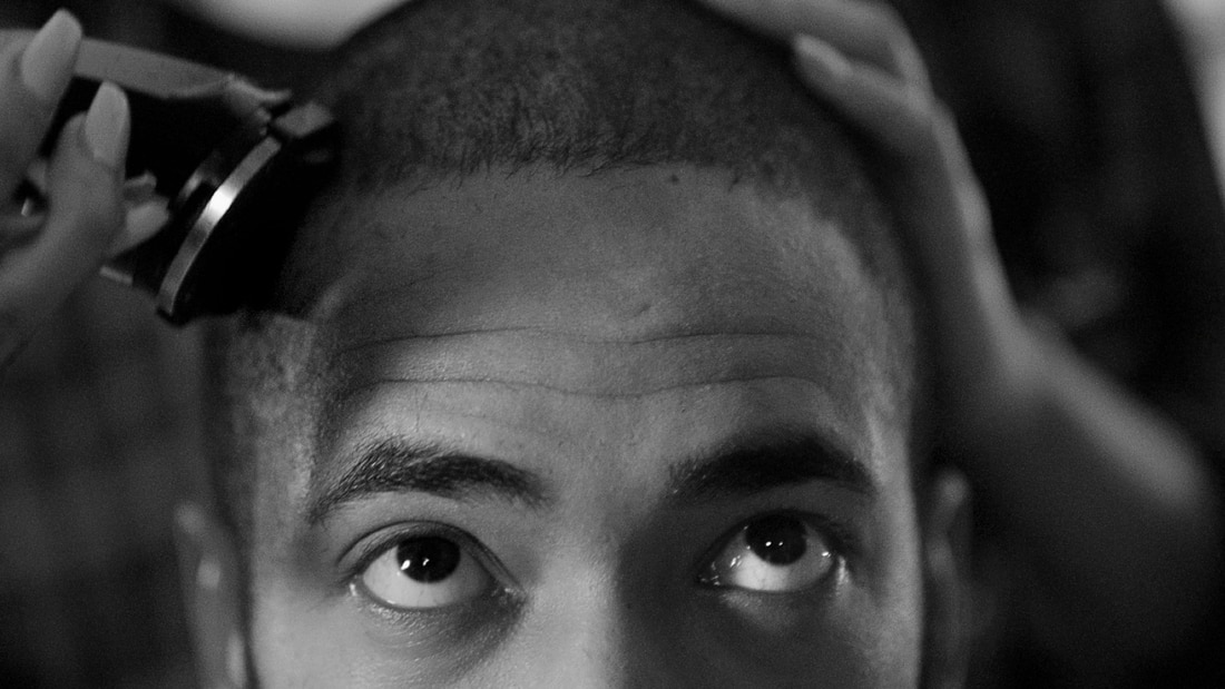 A guy with a crew cut, seen from the back.