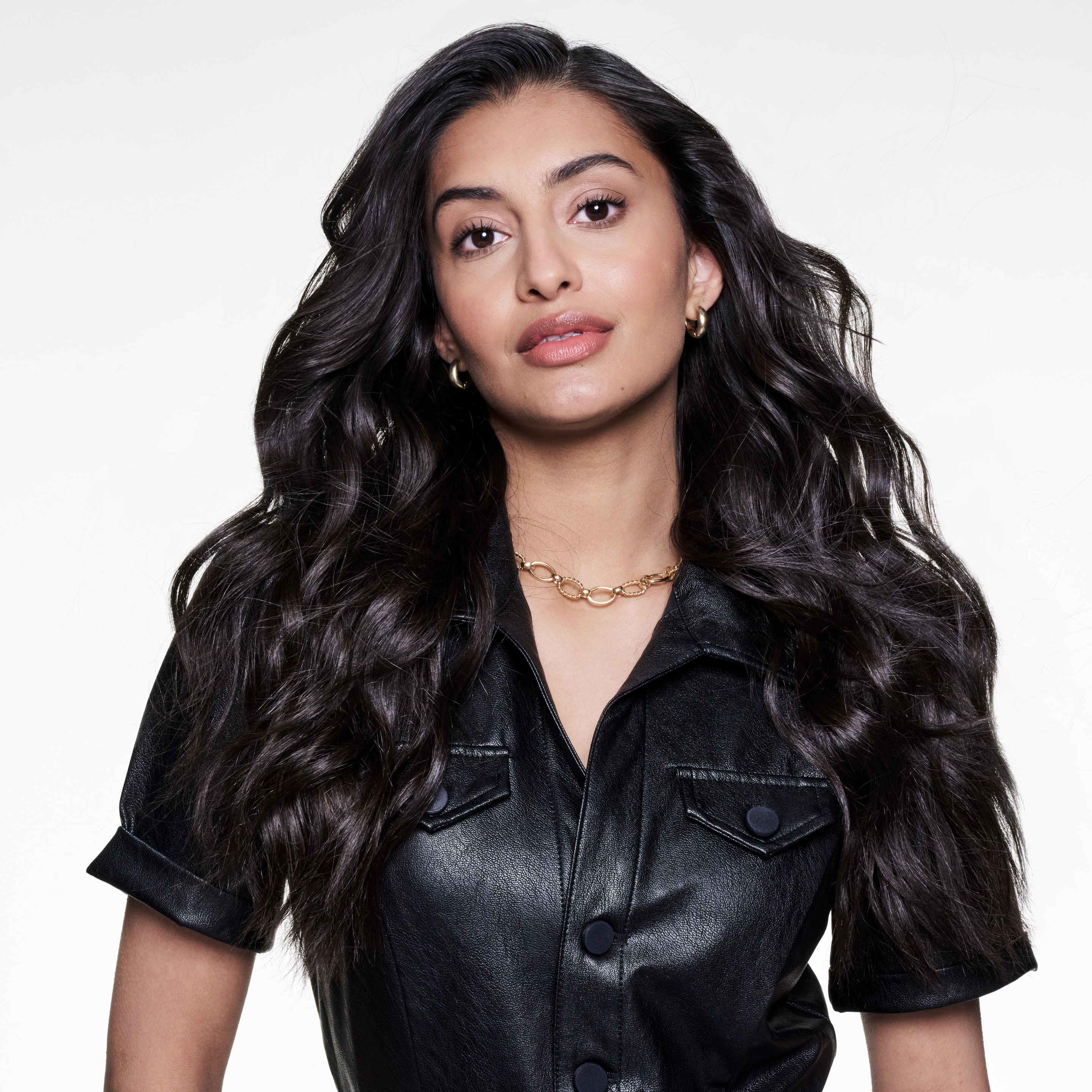 Model posing with long wavy dark brown hair