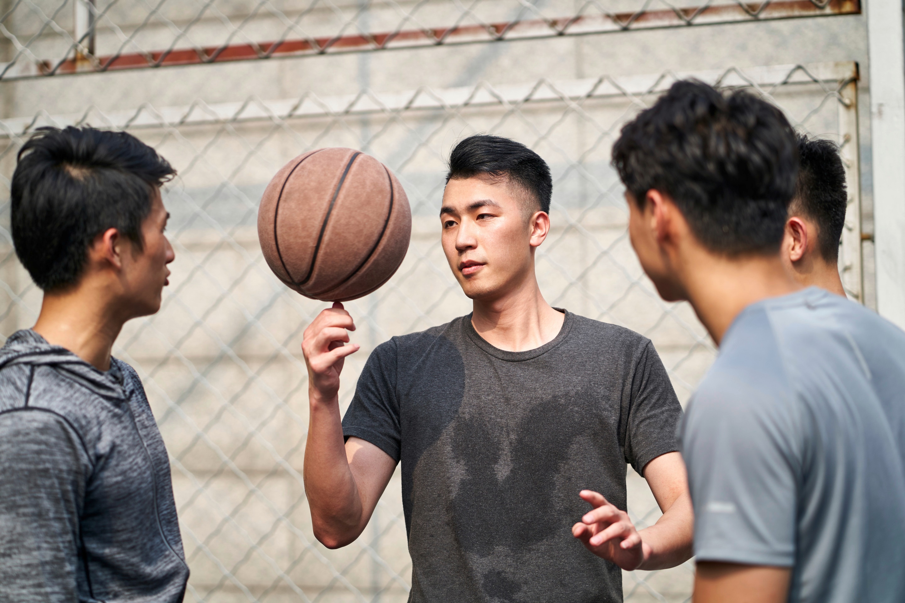 Group of friends playing basketball on the street 