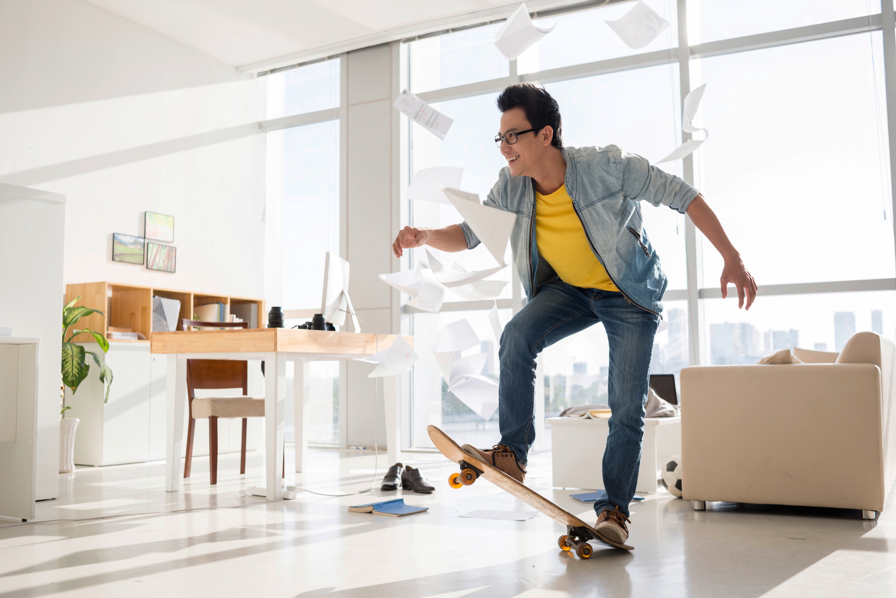 Asian man practicing skateboard indoors