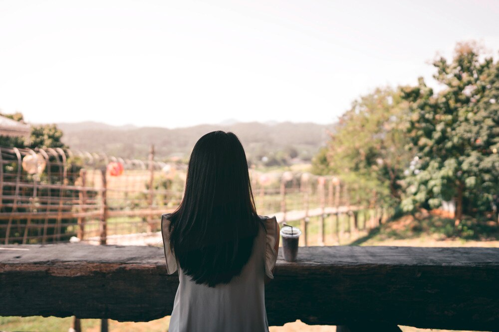 Back of an Asian woman with long, straight hair.