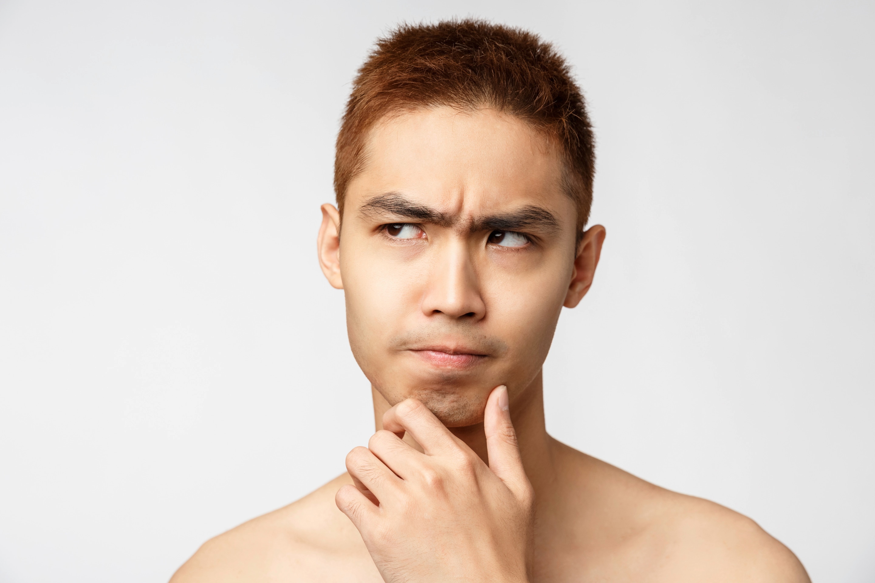 Asian man thinking and putting his hand on his chin