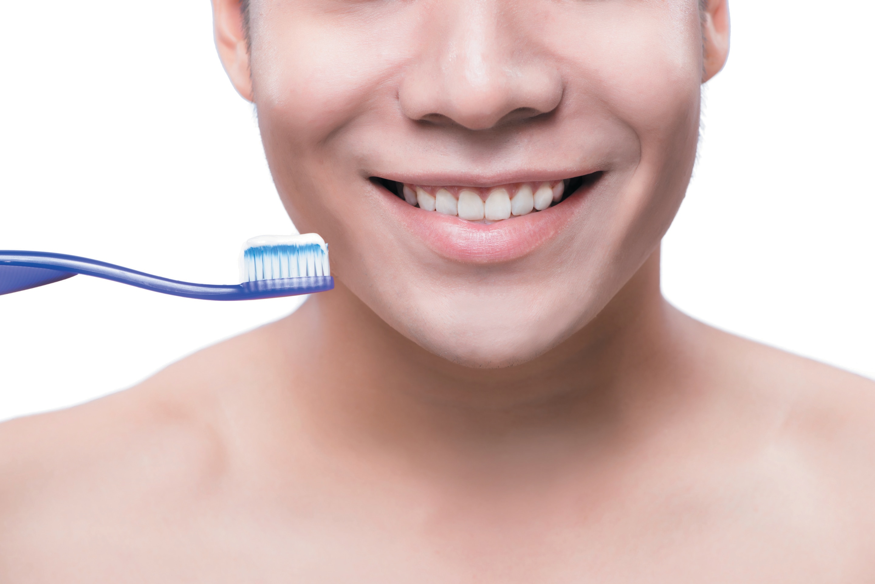 Closeup of Asian man holding a toothbrush and grinning