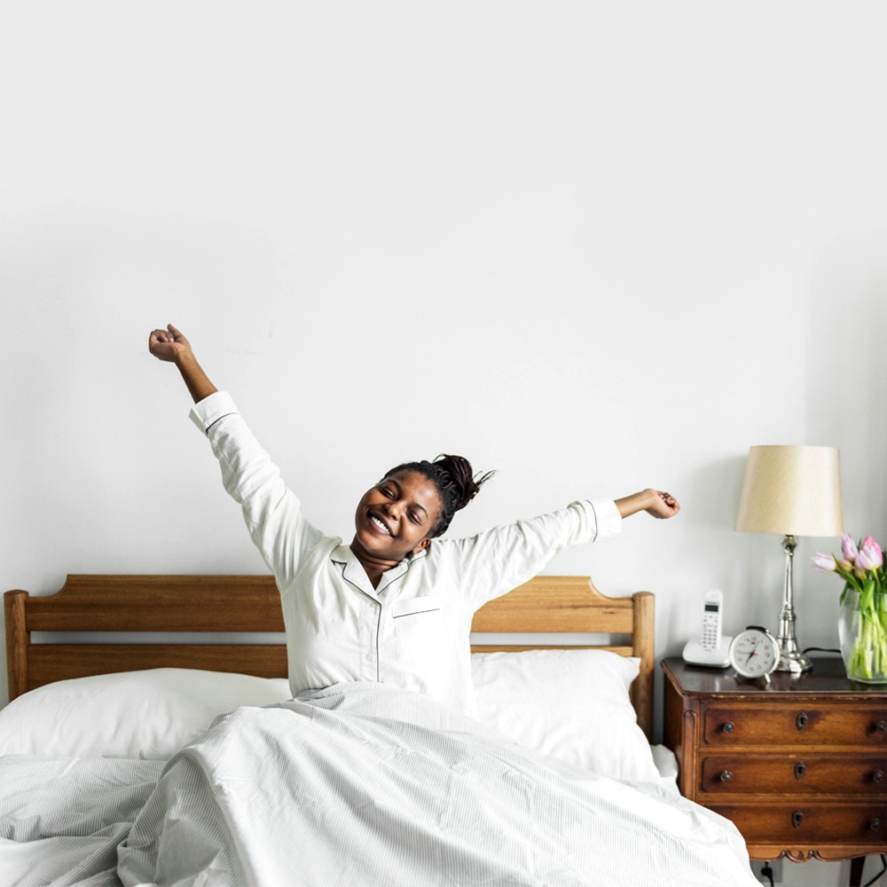 A beautiful woman waking up from sleep with even toned skin