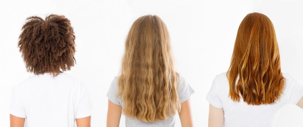 Rambut Sehat Wanita dengan rambut panjang, mengkilap menunjukkan tekstur rambutnya yang sehat dan terawat baik
