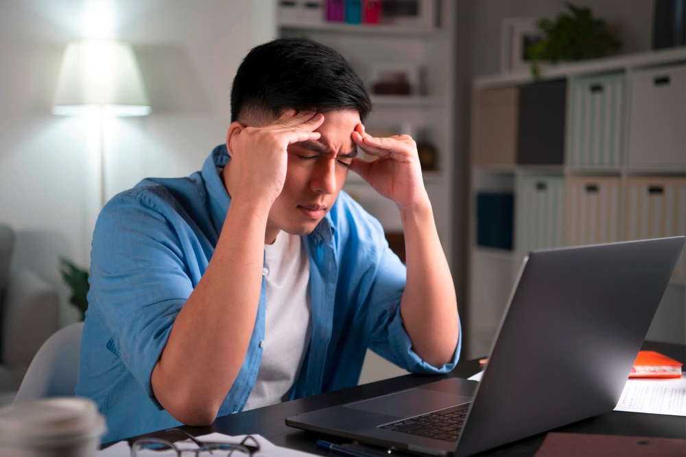 Stressed man working in front of his laptop.