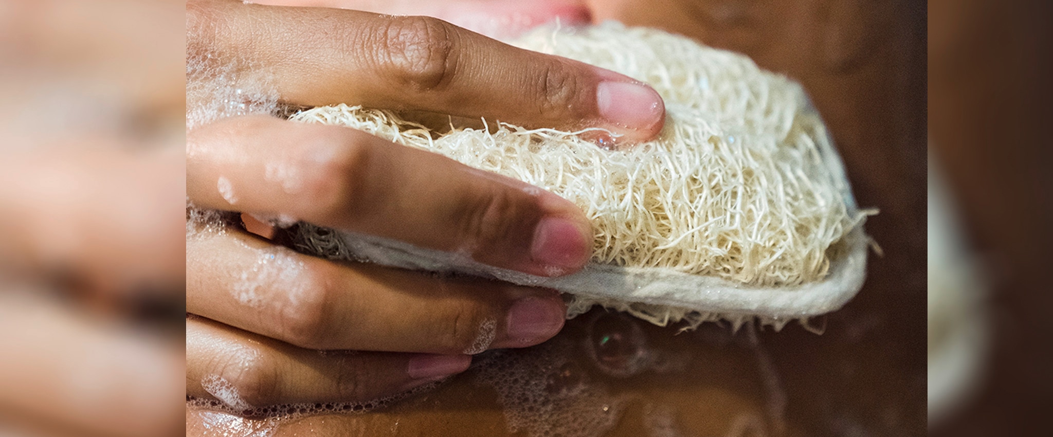 A woman washing her body with Lifebuoys charcoal bar for clearer, brighter skin