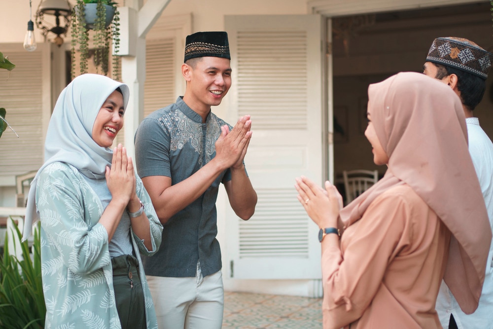 A portrait of friends welcoming each other during Eid al-Fitr.