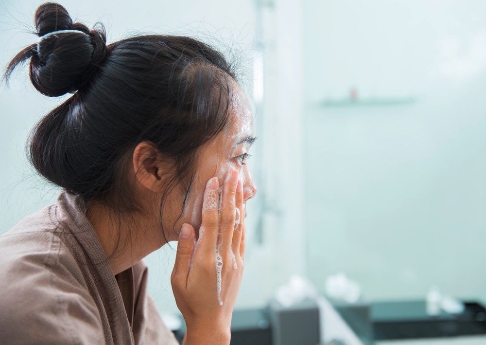 Asian woman washing face