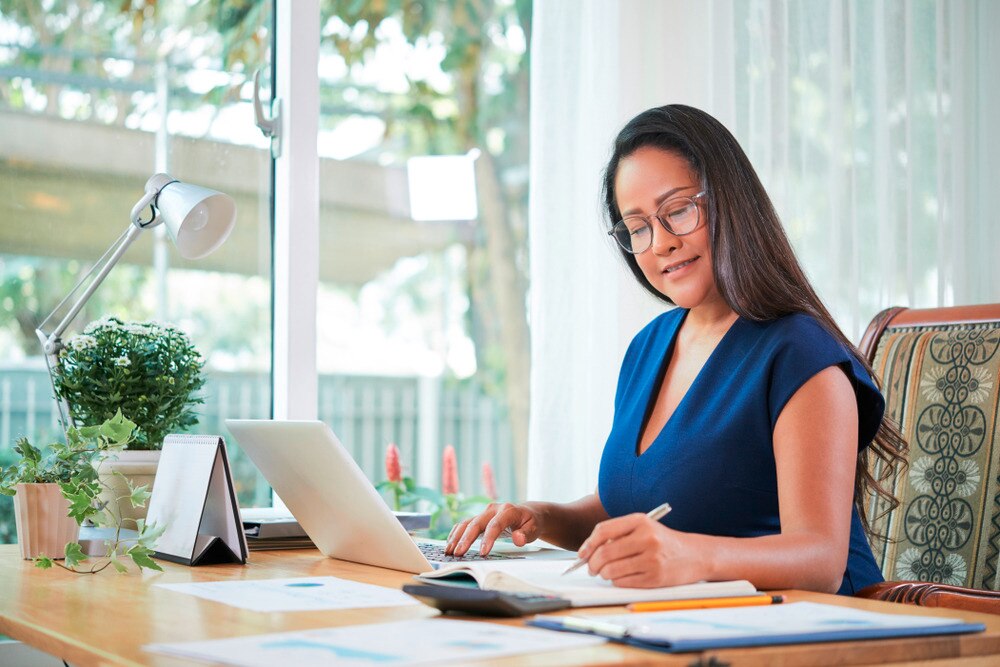 Female manager writing something down on her notepad.
