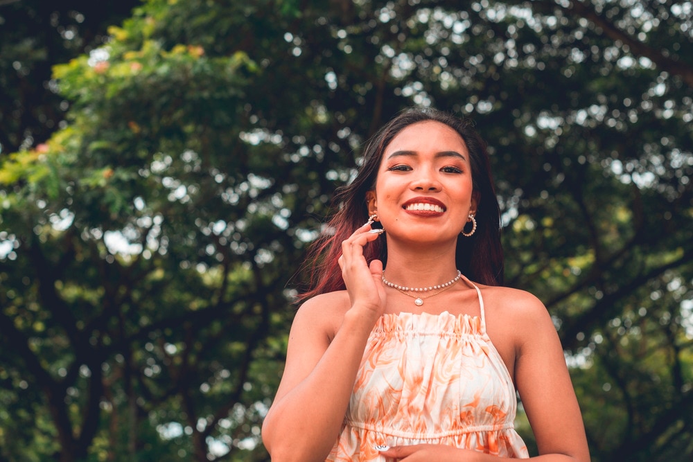 Smiling southeast Asian young woman in halter top.