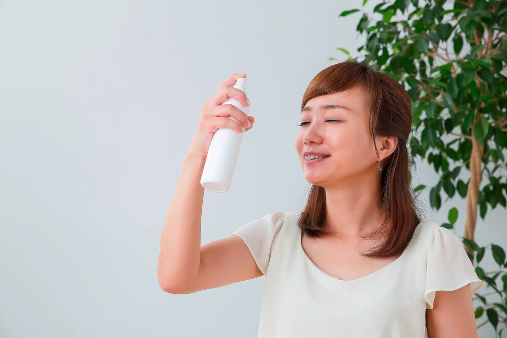 A portrait of woman using face mist.