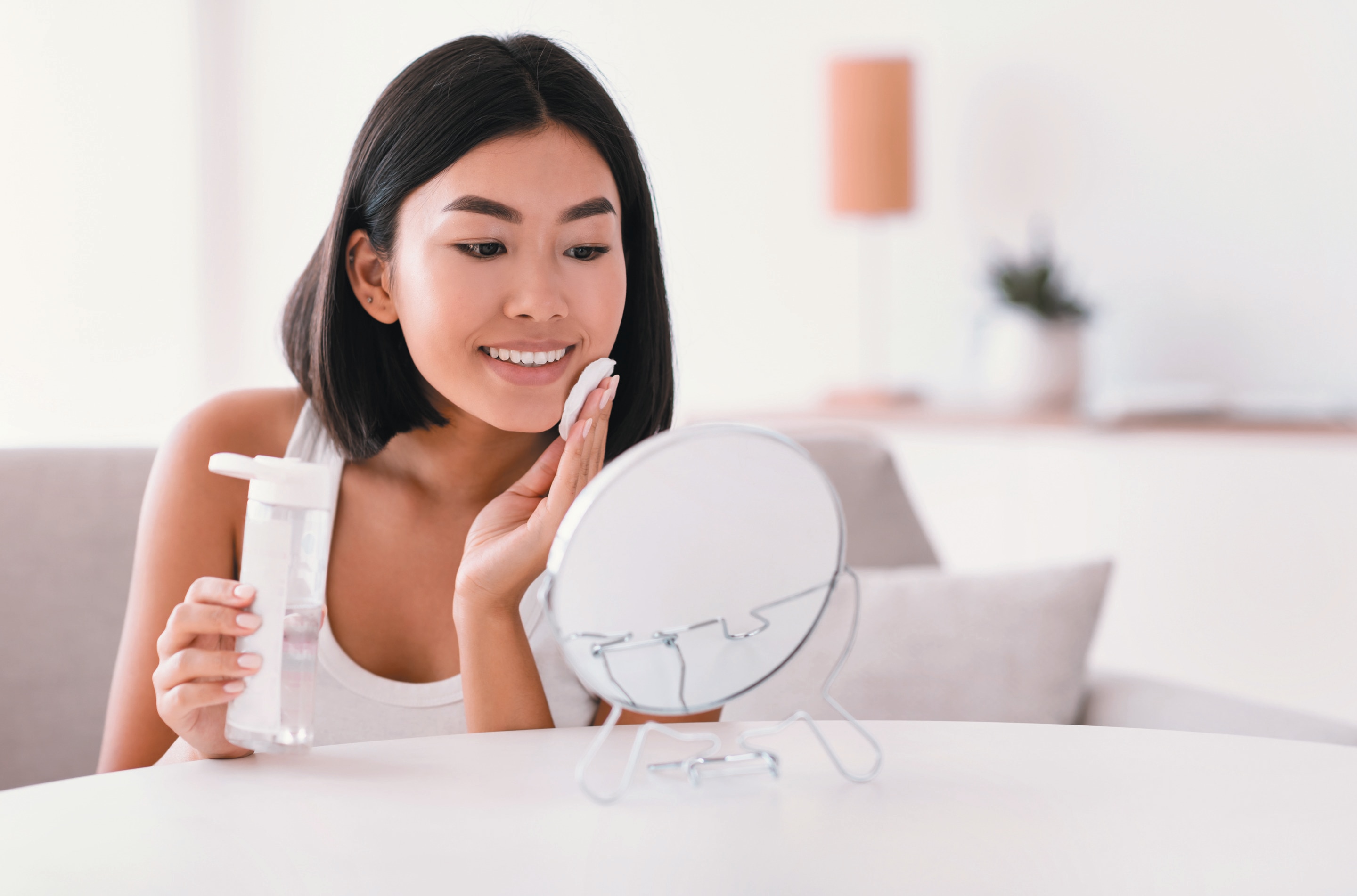 Asian woman applying toner