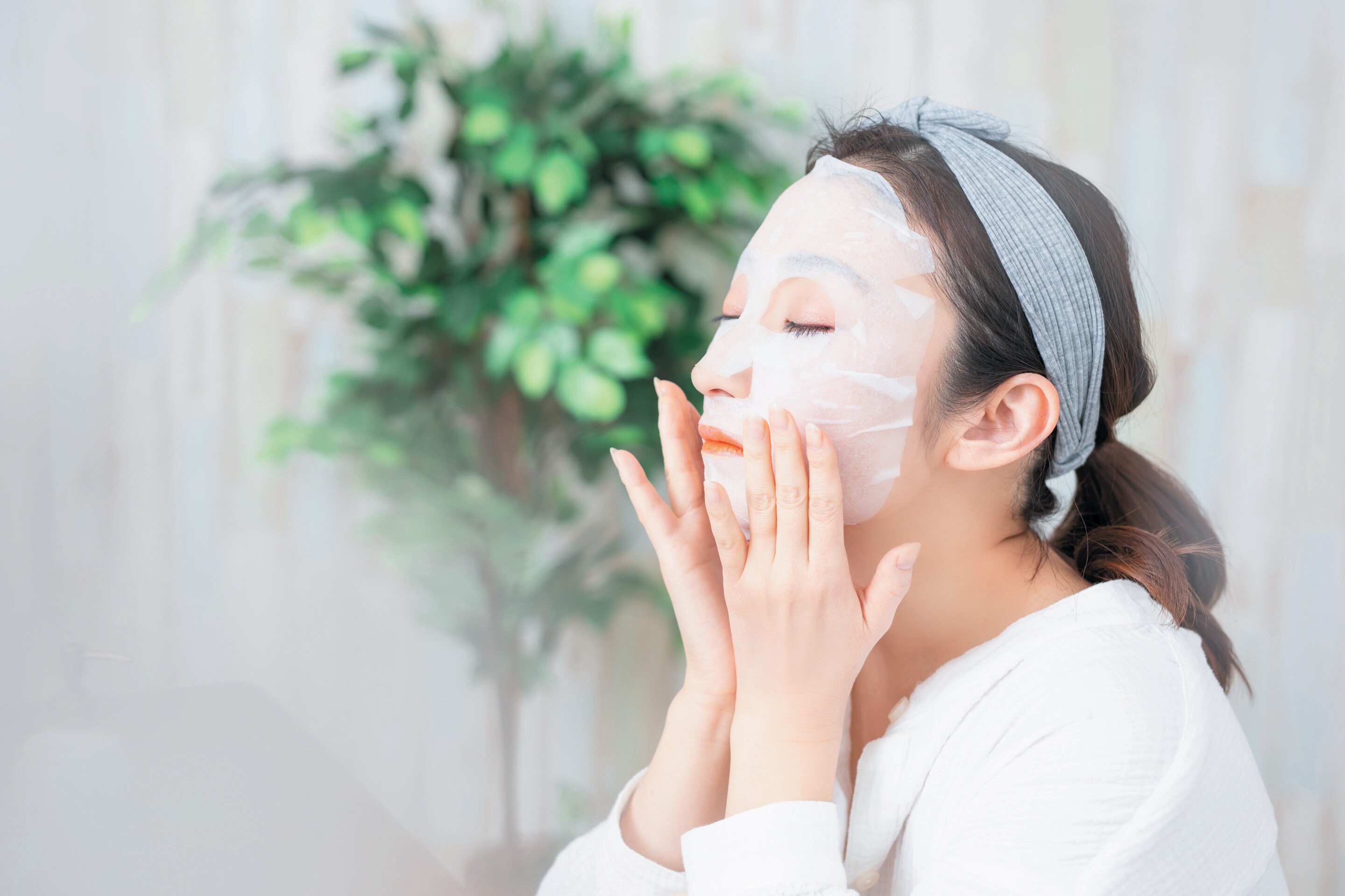 woman applying facial mask