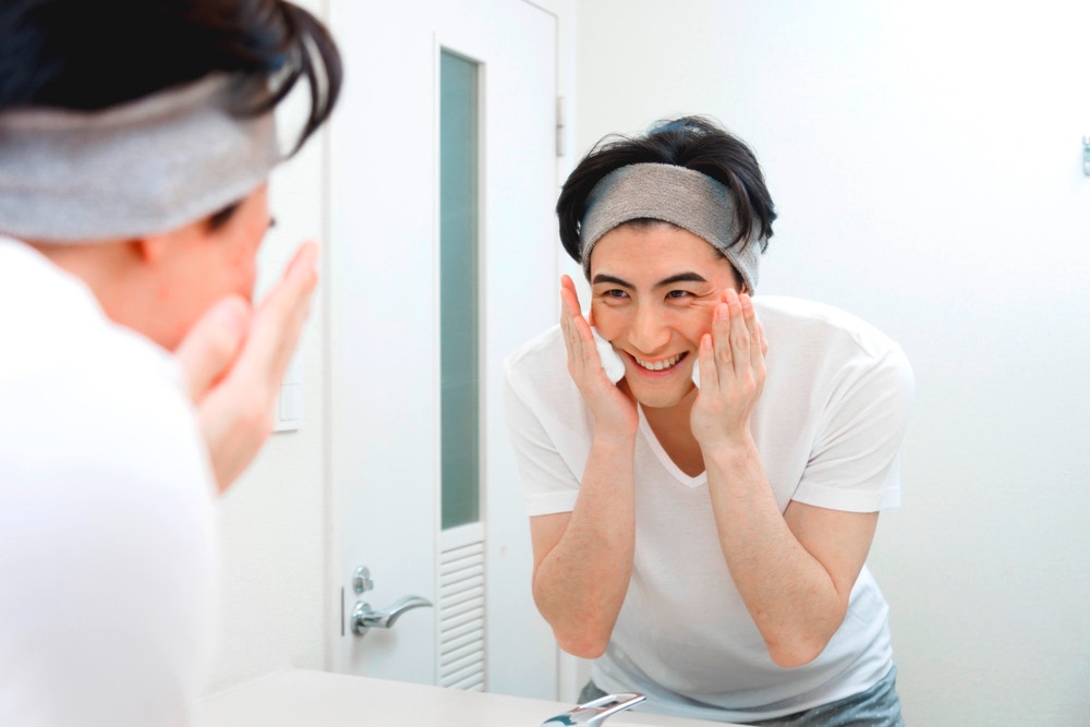 Man washing his face with foaming cleanser.