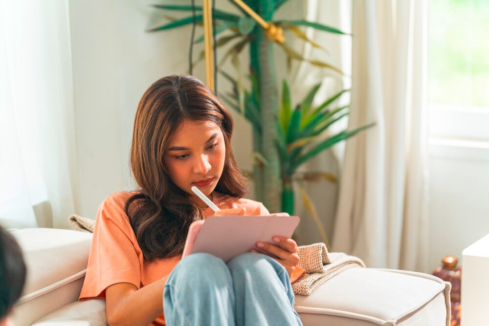Woman working on her digital tablet.