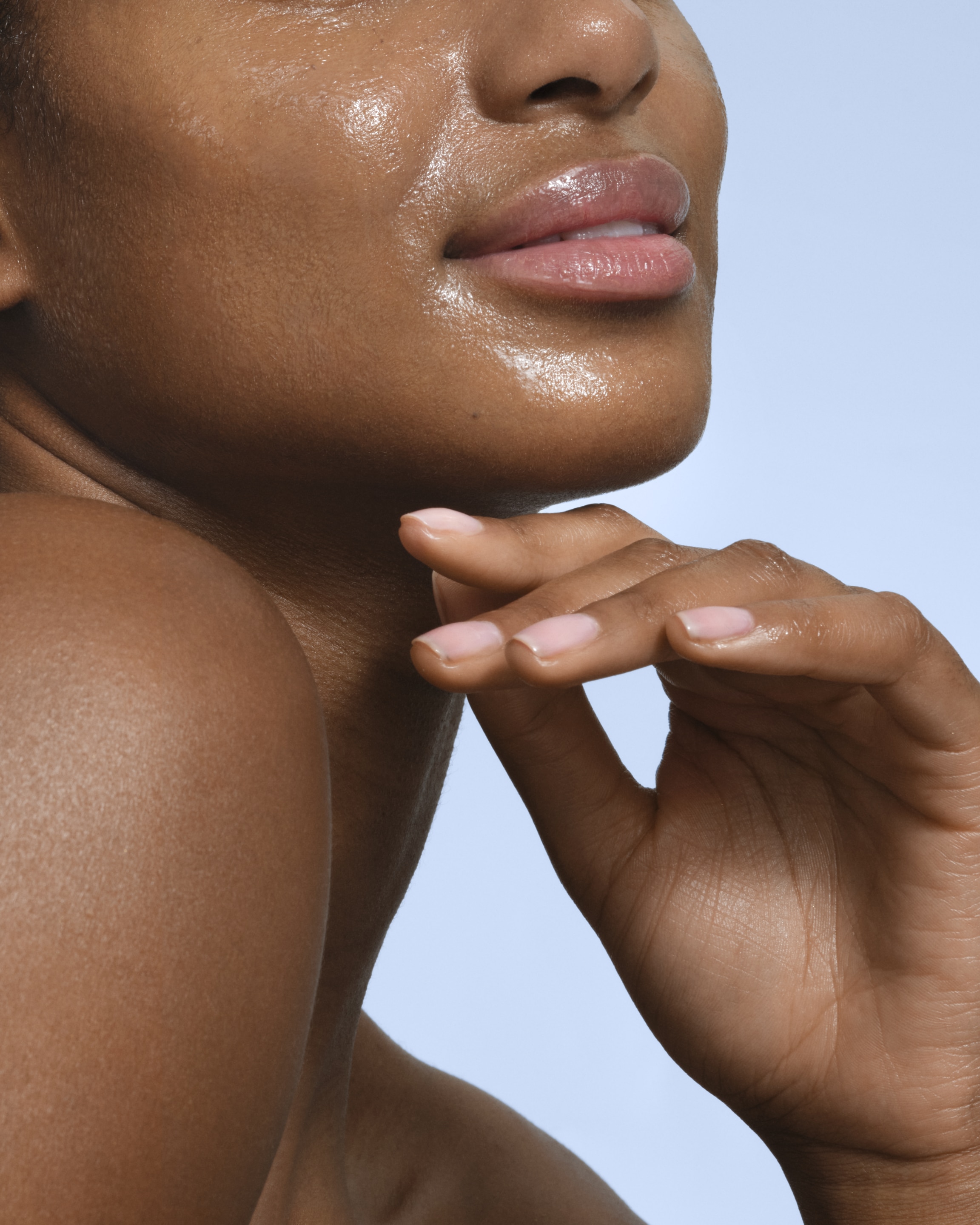 Woman applying cream on her face