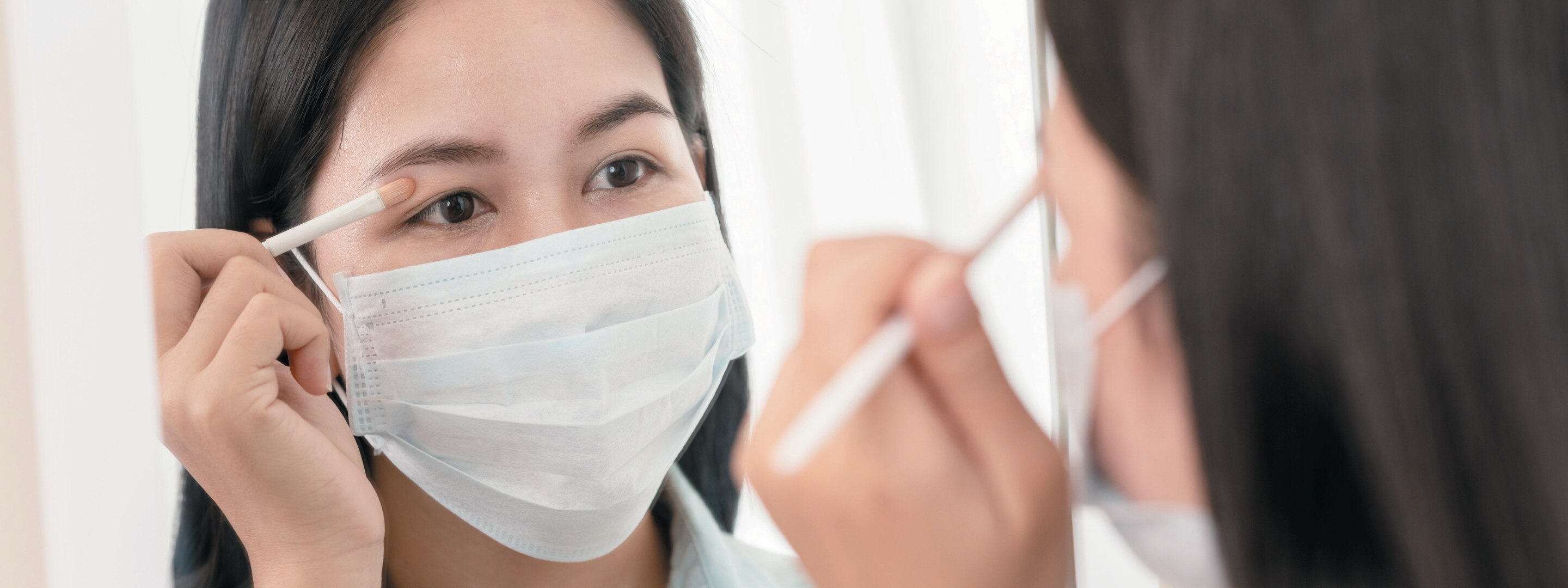 Asian woman wearing face mask and face shield
