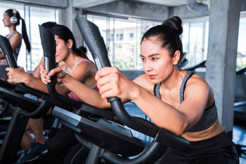 Women exercising at spin class.