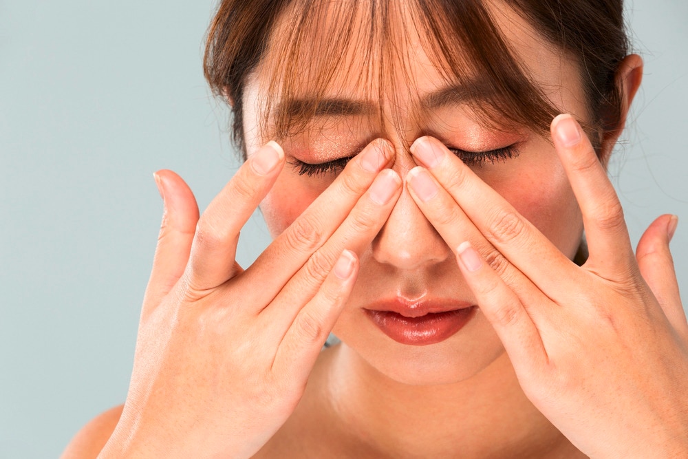 Woman massaging her eyes with her fingers.