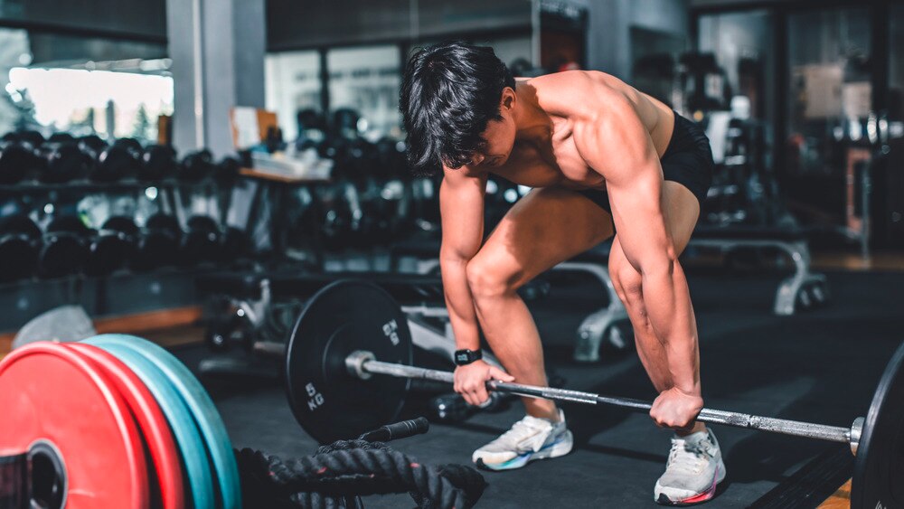 A portrait of man preparing to do a deadlift.