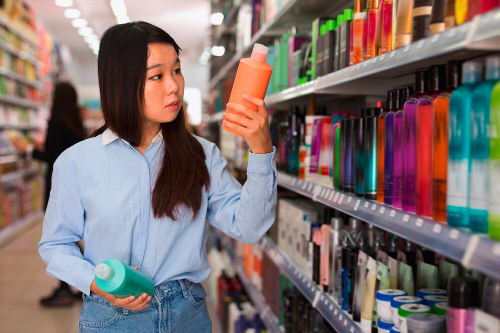 Asian woman choosing between products.