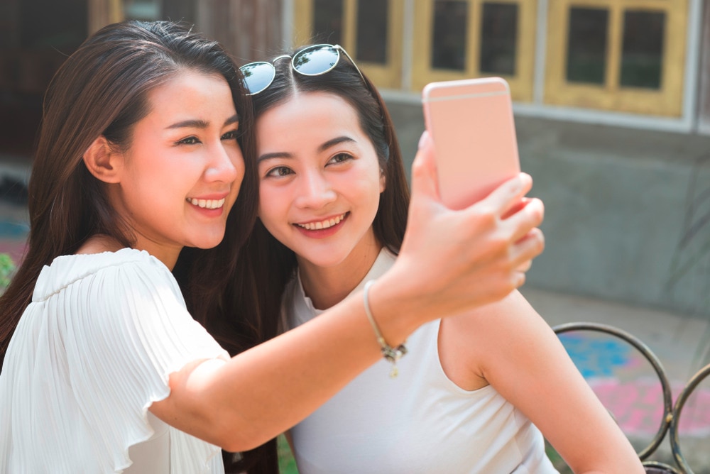 Two female friends taking a selfie selfie.