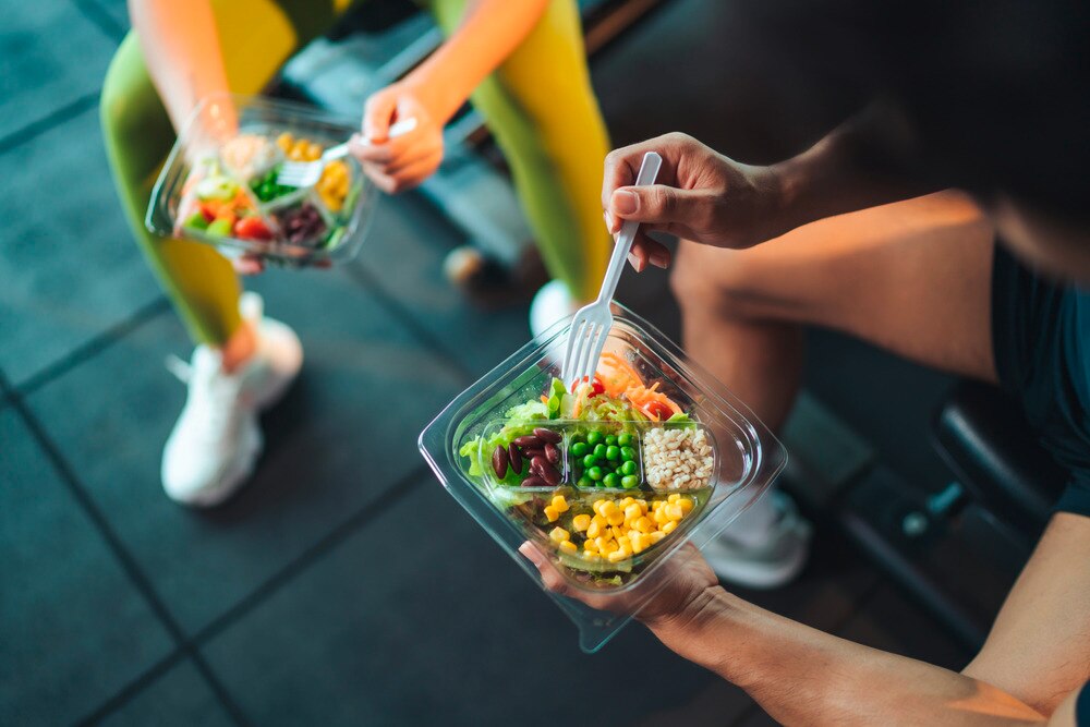 Top view of gym-goers having a salad.
