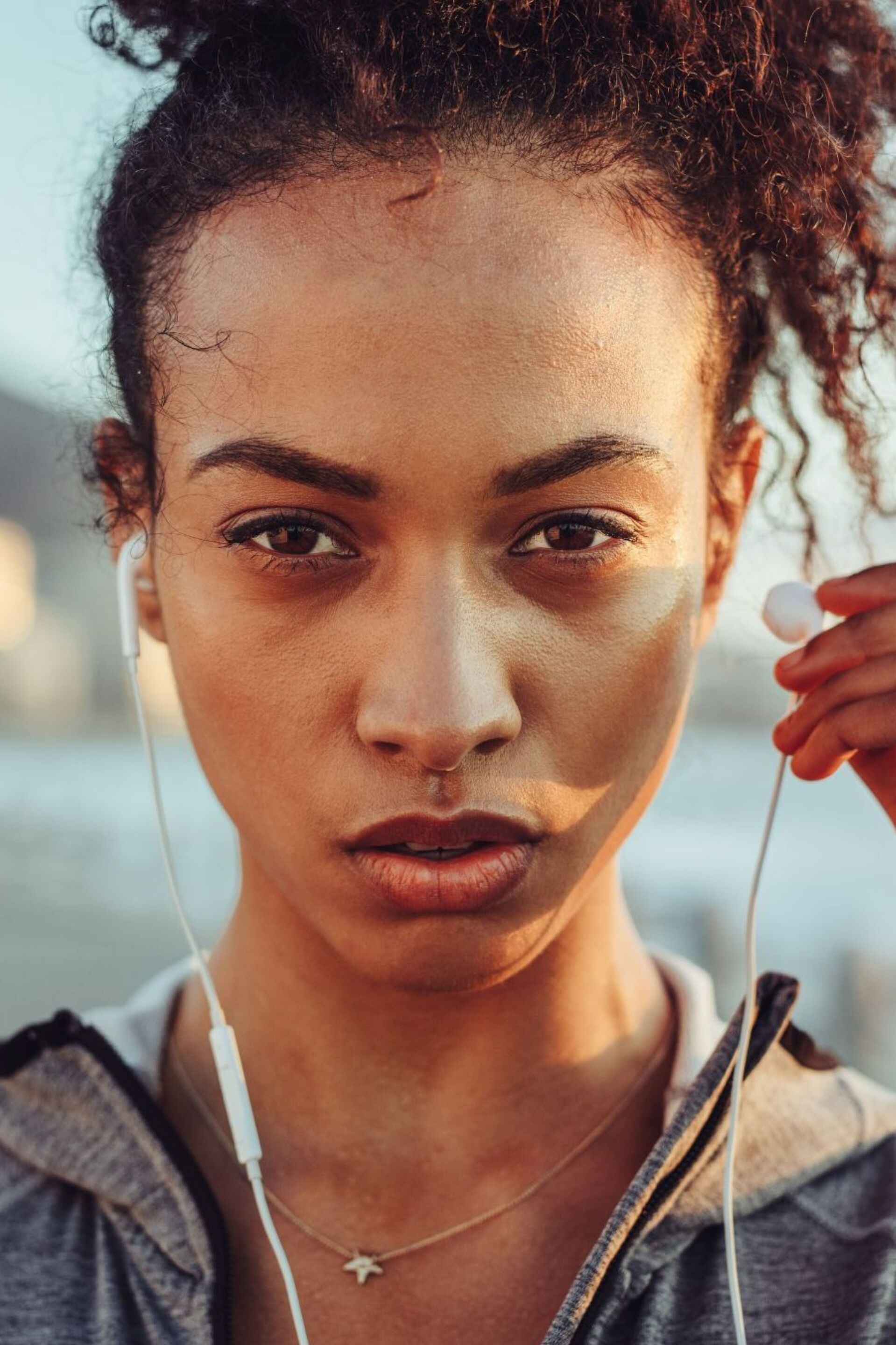 portrait of a woman putting on earphones