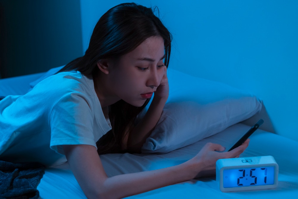 Woman texting in the middle of the night.