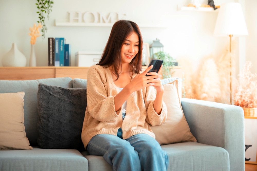 Woman browsing an online shopping application on her mobile phone.