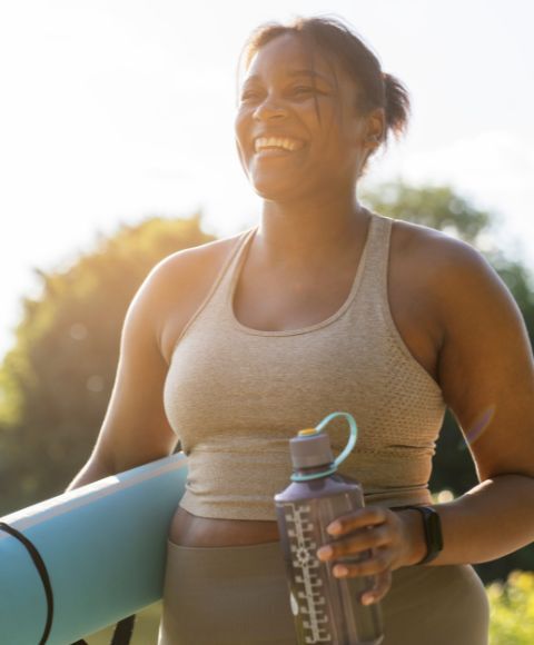 Mujer afroamericana feliz en su camino al yoga