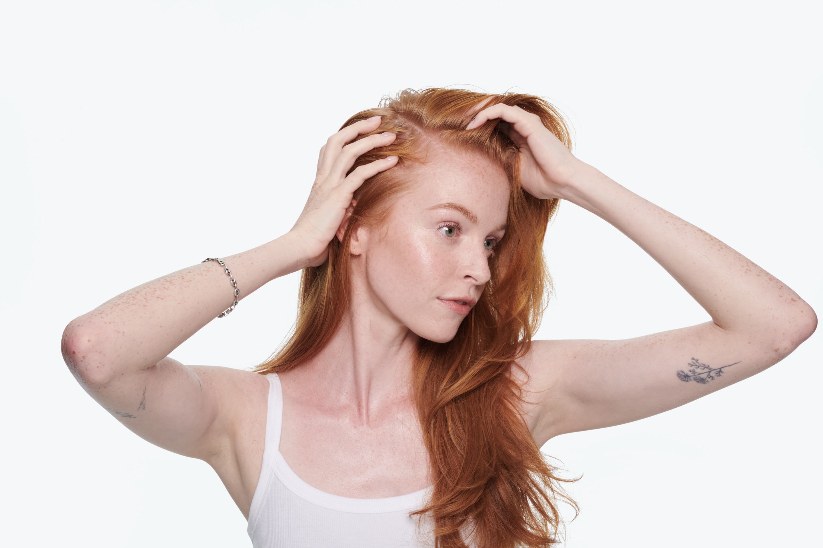 woman with long red hair looking away from the camera