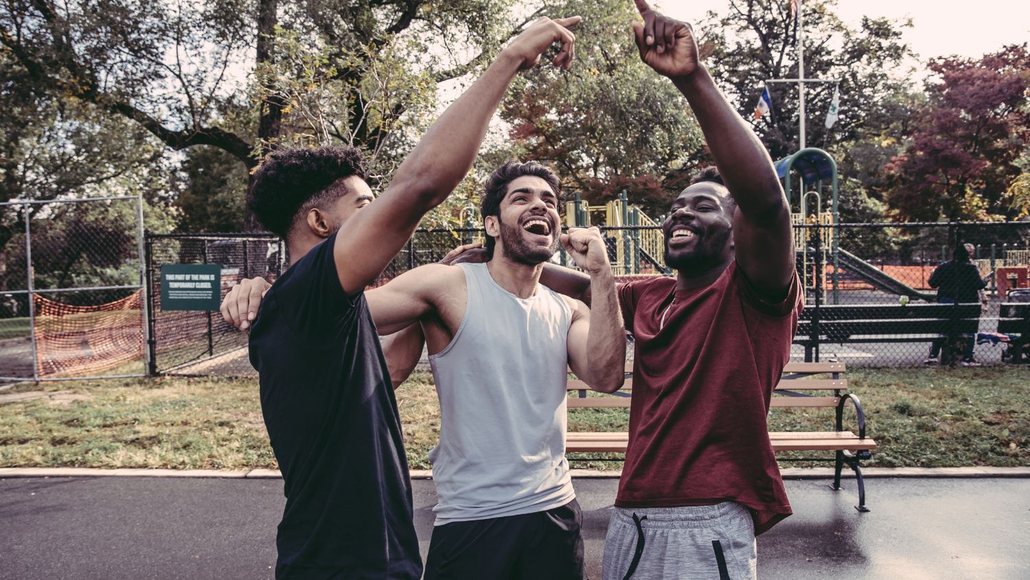 Three young men celebrating outdoors
