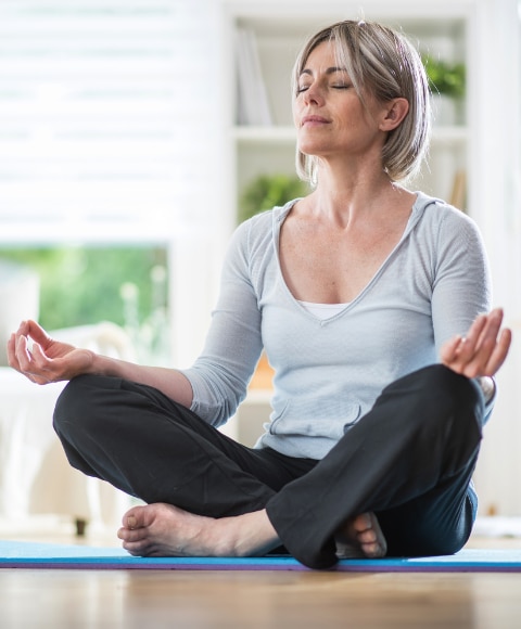 Woman in her 40s practicing yoga and meditation 