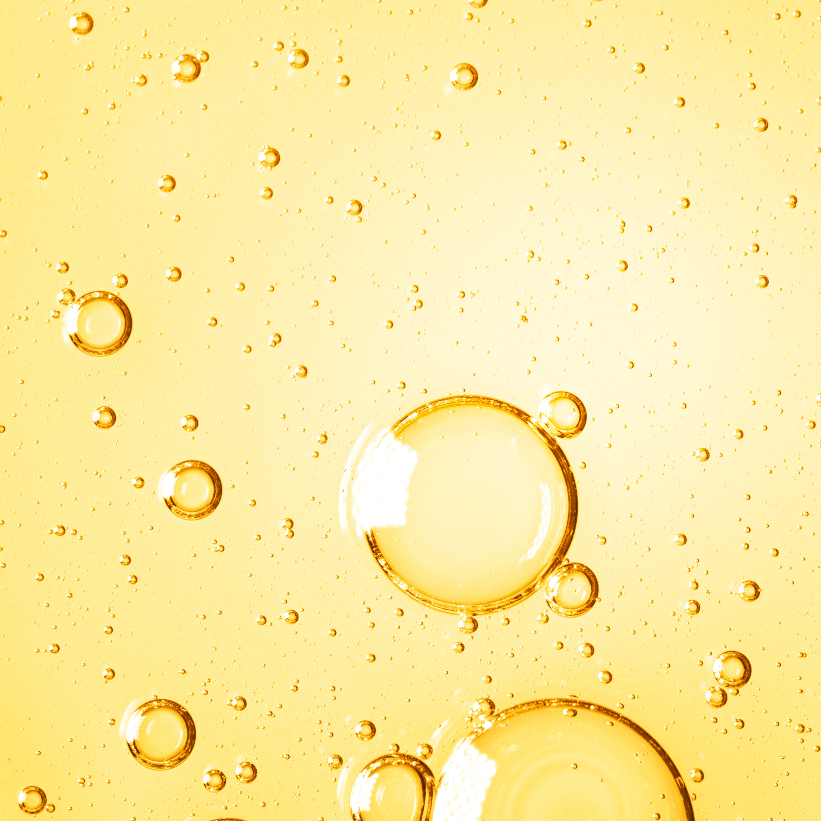 Oil droplets on yellow background