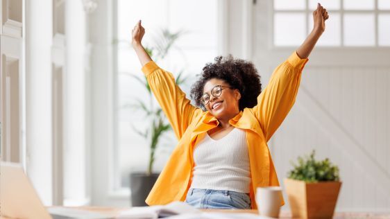 Happy woman sitting at her desk working