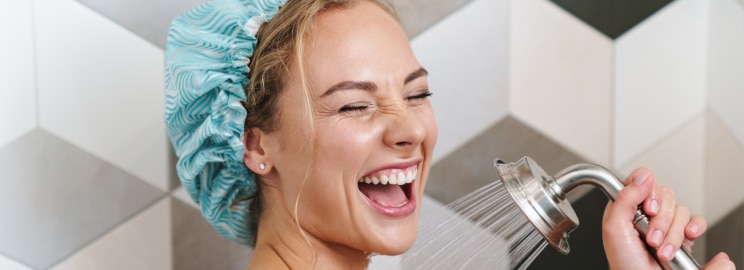 Happy woman taking an everything shower at home