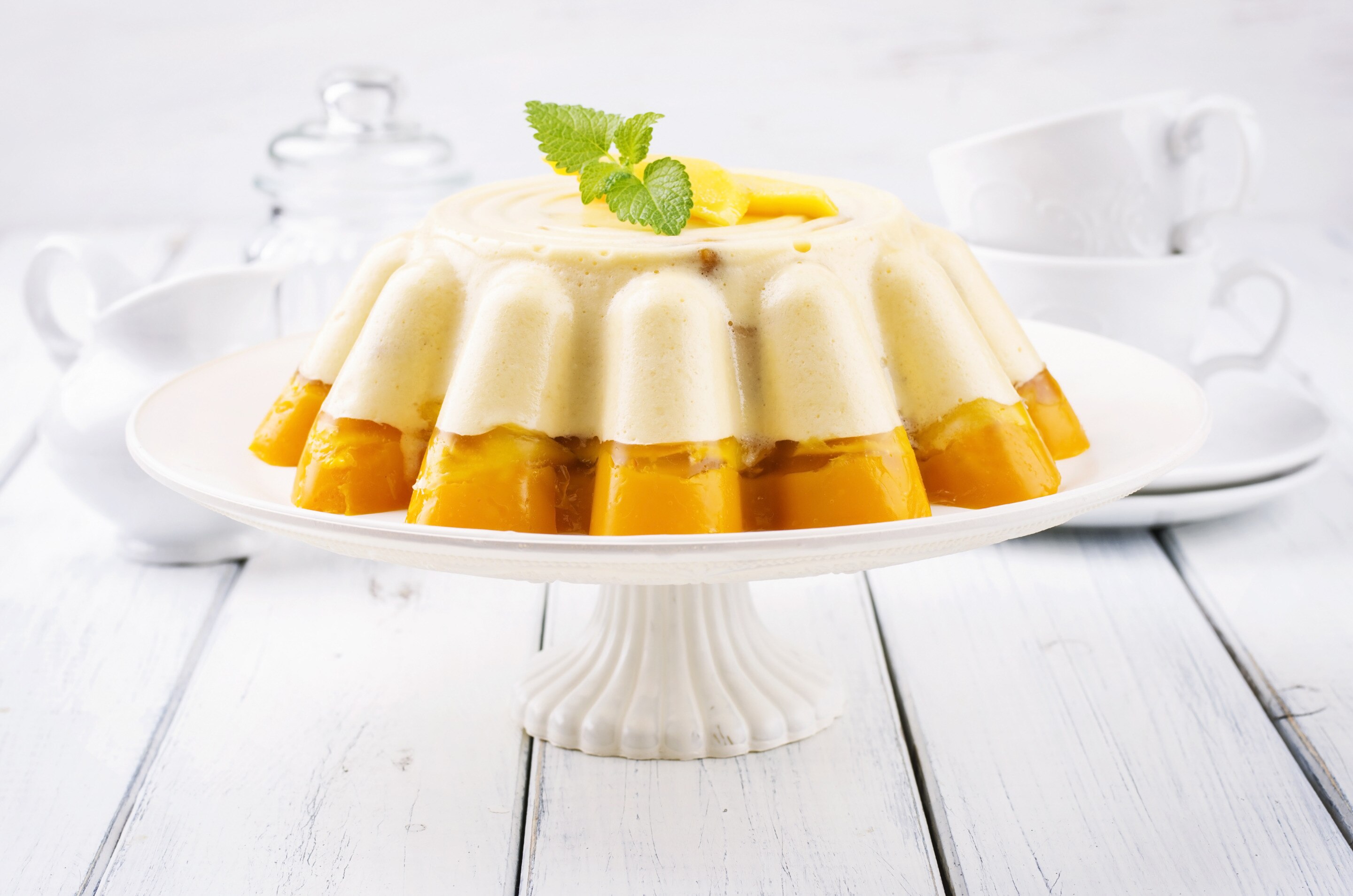 Mango gelatin on a decorative cake stand.