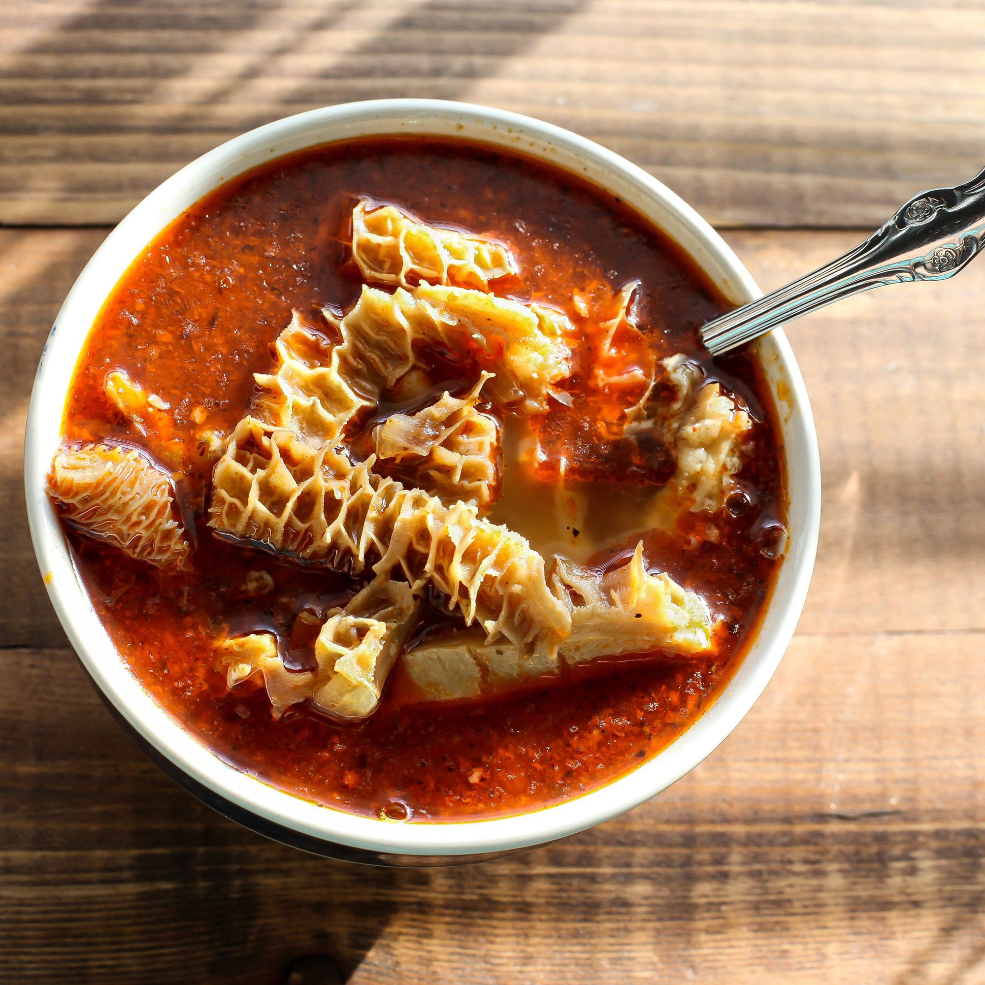 Beef tripe soup on wooden table top view