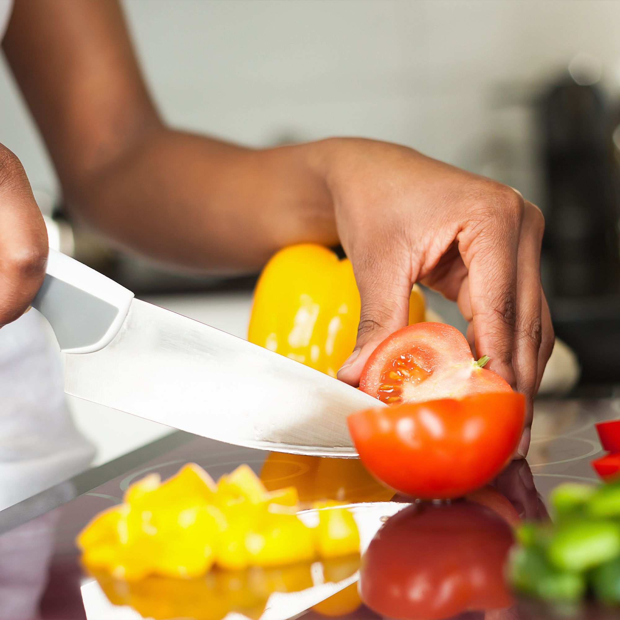 Woman slicing a tomato