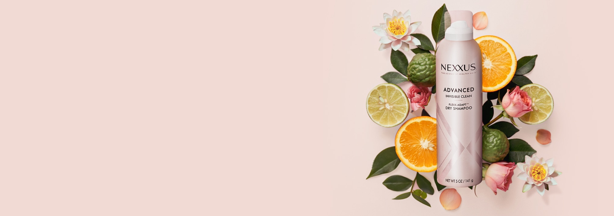 Nexxus Hy-Volume volumizing shampoo, a shampoo for fuller hair, surrounded by ginger, rosemary and bergamot.