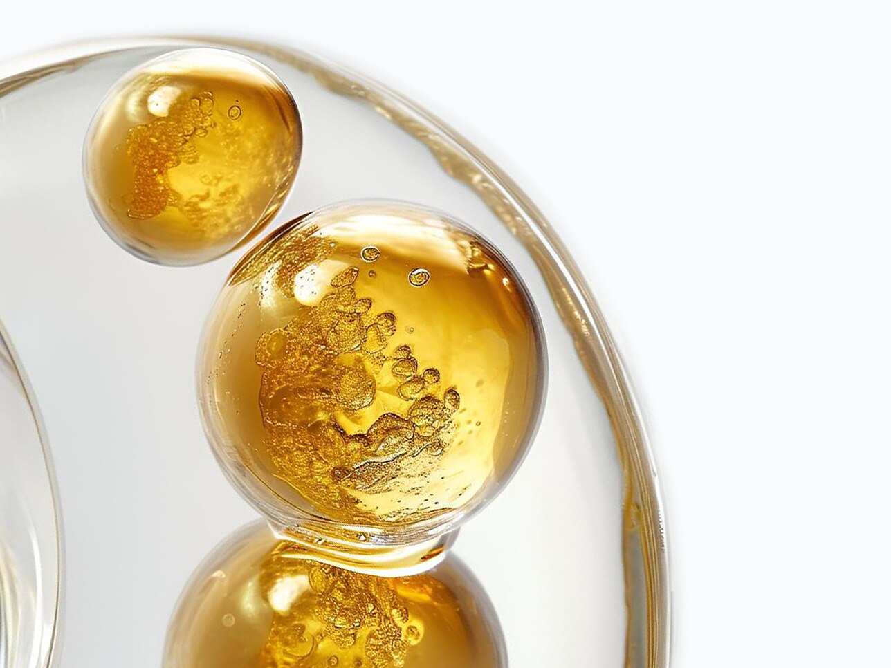 Close up image of golden bubbles with an off white background