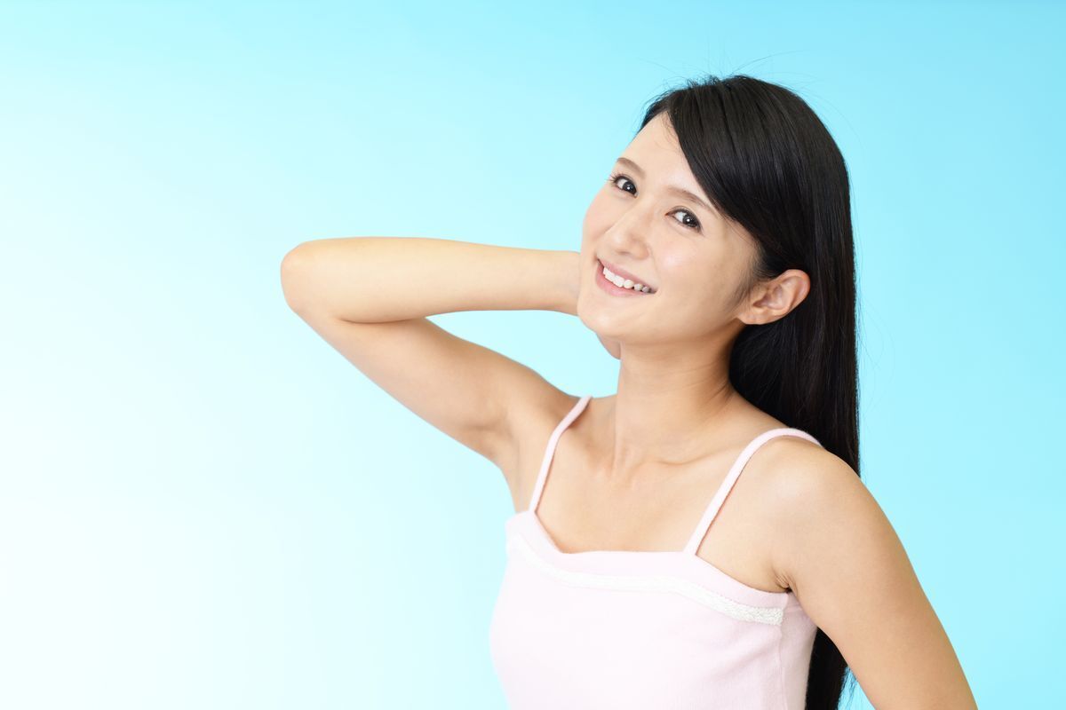 Asian woman holding arm up